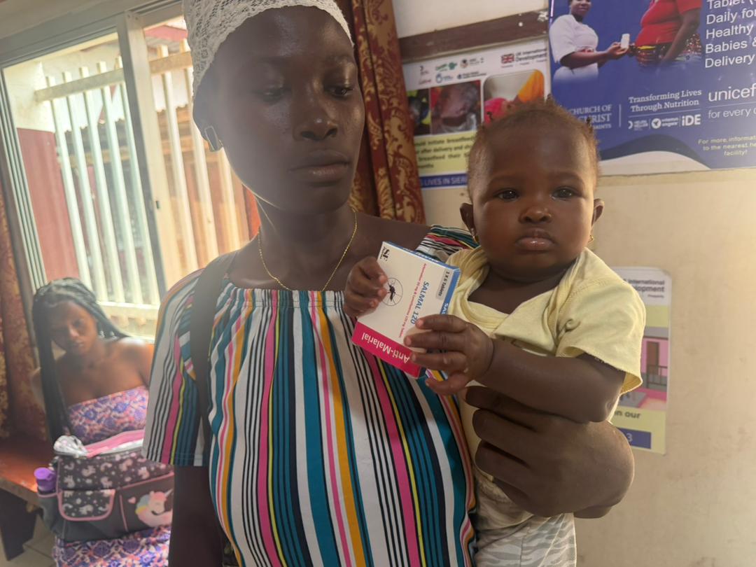 Mother and child receiving anti-malarial treatment