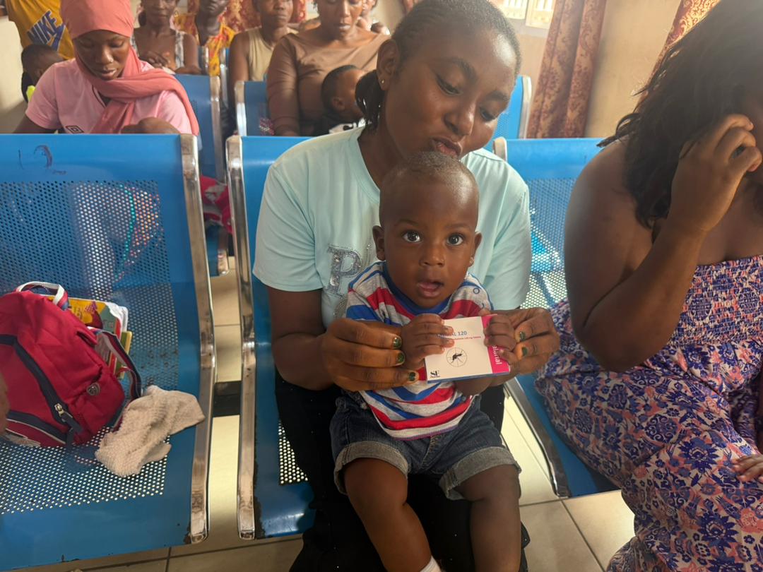 Mother and child at clinic with anti-malarial treatment